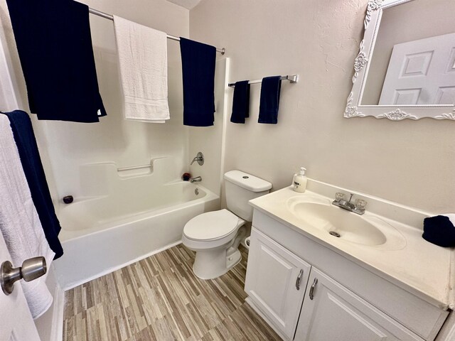3180 N Ridge Rd -, Unit Tallahassee, FL 32305 - bathroom featuring vanity, toilet, wood finished floors, and bathtub / shower combination