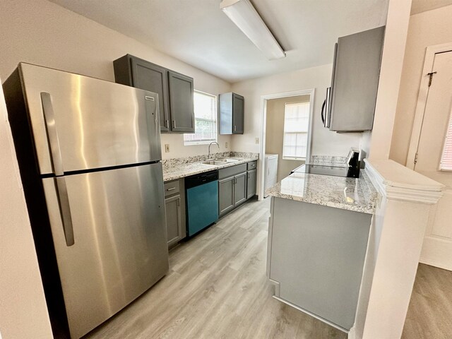 3180 N Ridge Rd -, Unit Tallahassee, FL 32305 - kitchen featuring freestanding refrigerator, dishwashing machine, stove, a sink, and light wood-style flooring