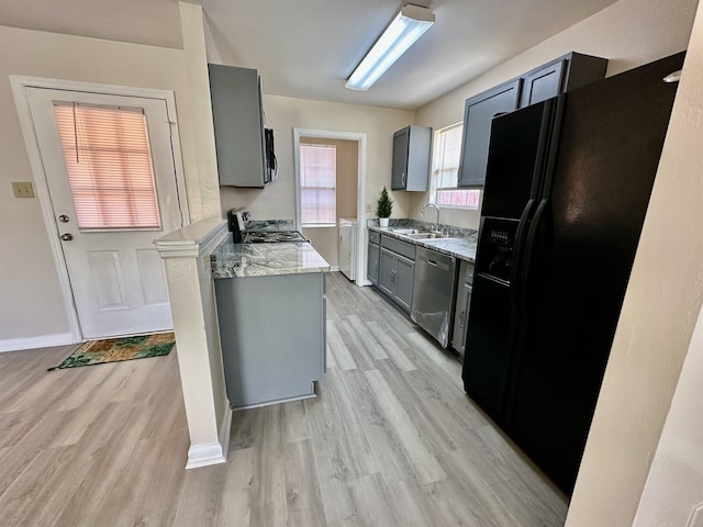 3180 N Ridge Rd -, Unit Tallahassee, FL 32305 - kitchen featuring baseboards, a sink, appliances with stainless steel finishes, and light wood-style flooring