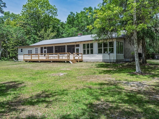 881 Hickory Hammock Rd, Carrabelle, FL 32322 - rear view of property with a wooden deck, a lawn, and a sunroom