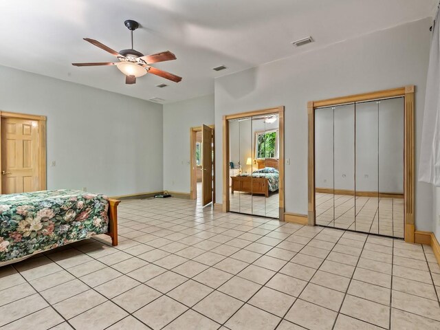 881 Hickory Hammock Rd, Carrabelle, FL 32322 - bedroom with multiple closets, light tile patterned floors, baseboards, and a ceiling fan