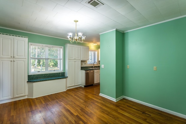 253 Prado St, Apalachicola, FL 32320 - kitchen with dishwasher, dark countertops, a chandelier, ornamental molding, and white cabinets
