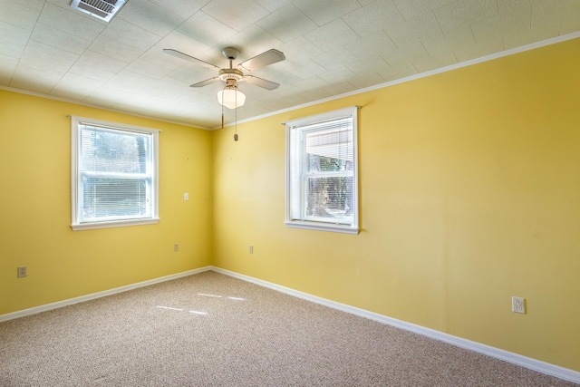 253 Prado St, Apalachicola, FL 32320 - carpeted empty room featuring ornamental molding, healthy amount of natural light, ceiling fan, and baseboards