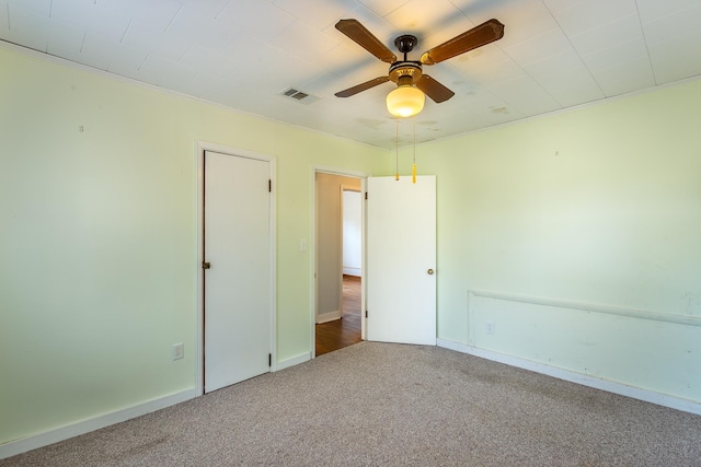 253 Prado St, Apalachicola, FL 32320 - unfurnished bedroom with carpet, baseboards, and ceiling fan