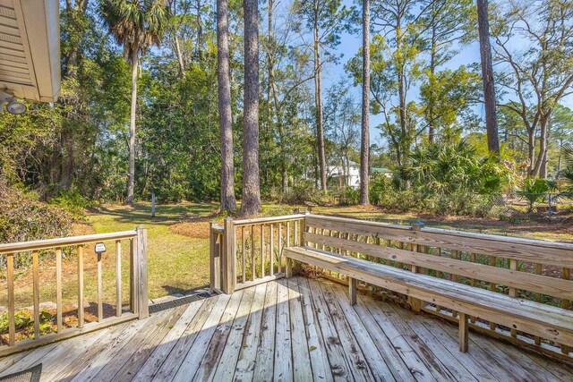 253 Prado St, Apalachicola, FL 32320 - wooden deck featuring view of wooded area
