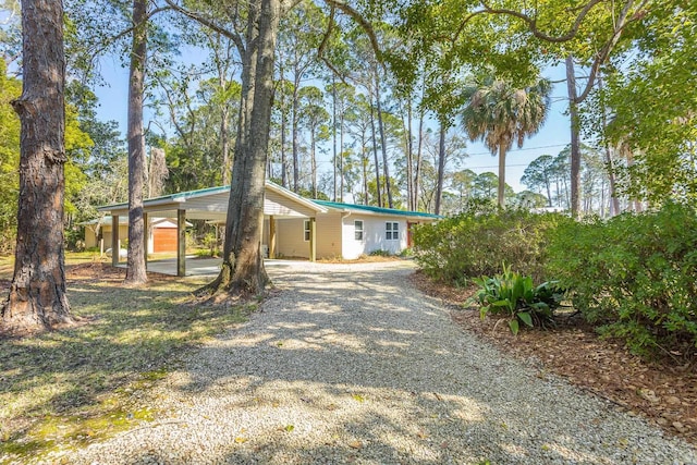 253 Prado St, Apalachicola, FL 32320 - view of front of house with gravel driveway and a carport