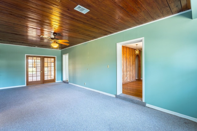 253 Prado St, Apalachicola, FL 32320 - spare room with carpet floors, baseboards, a ceiling fan, wooden ceiling, and french doors