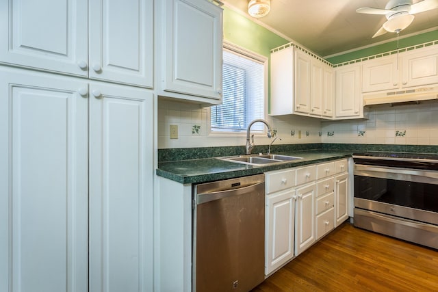 253 Prado St, Apalachicola, FL 32320 - kitchen featuring a sink, stainless steel appliances, under cabinet range hood, dark countertops, and white cabinetry