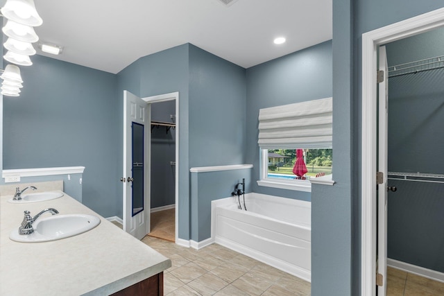 1094 Paul Thompson Rd, Monticello, FL 32344 - bathroom featuring a spacious closet, double vanity, and a garden tub