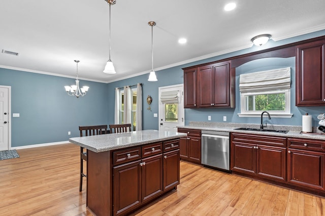 1094 Paul Thompson Rd, Monticello, FL 32344 - kitchen with dishwasher, a sink, a breakfast bar area, light wood-style flooring, and decorative light fixtures