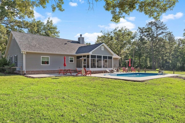 1094 Paul Thompson Rd, Monticello, FL 32344 - rear view of property featuring a sunroom, a patio area, a chimney, an outdoor pool, and a shingled roof
