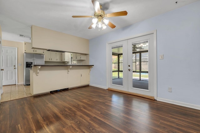 4054 Mcleod Dr, Tallahassee, FL 32303 - kitchen with stainless steel refrigerator with ice dispenser, a peninsula, french doors, dark countertops, and ceiling fan