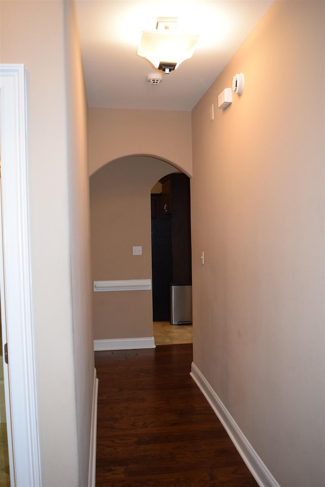 5657 Jacksons Gap Rd, Tallahassee, FL 32317 - hall with arched walkways, wood finished floors, and baseboards