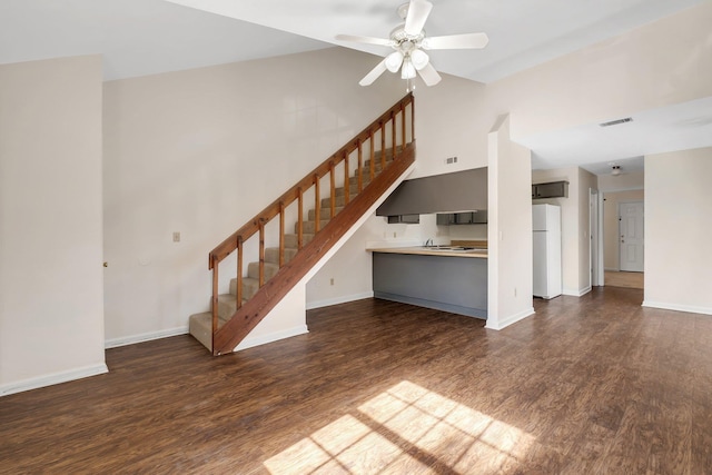 unfurnished living room with ceiling fan and dark hardwood / wood-style floors