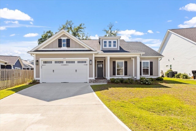 view of front facade featuring central AC, a garage, and a front lawn