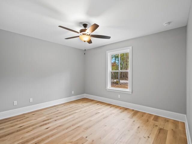 empty room with light wood-type flooring and ceiling fan