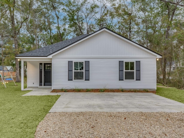 back of property featuring a playground and a lawn