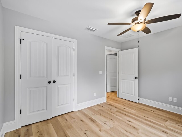 unfurnished bedroom featuring a closet, ceiling fan, and light hardwood / wood-style flooring