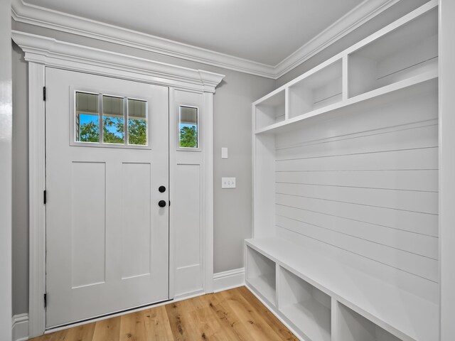 mudroom featuring light wood-type flooring and crown molding