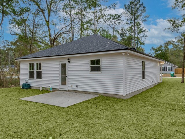 rear view of property with a lawn and a patio area