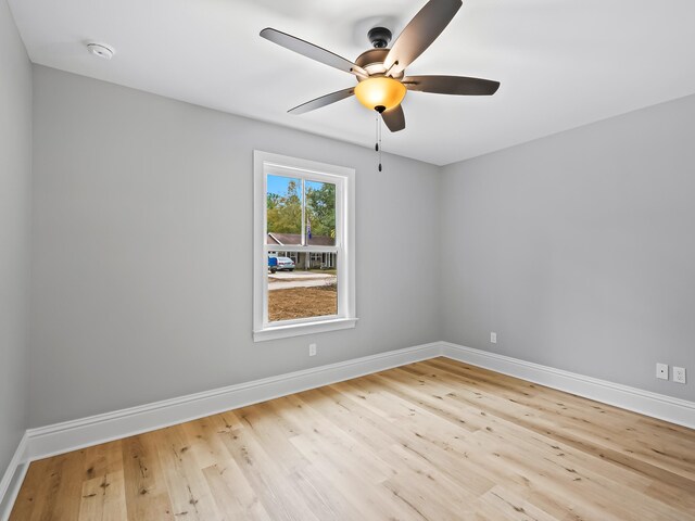 empty room with light wood-type flooring and ceiling fan