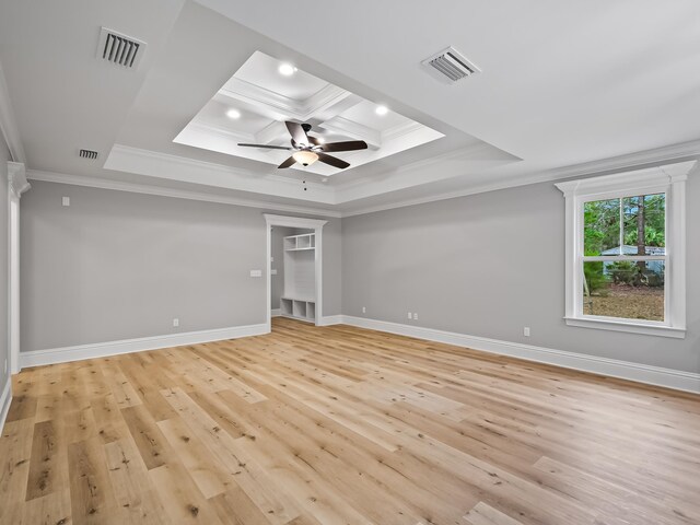 unfurnished bedroom with light hardwood / wood-style floors, ceiling fan, a raised ceiling, and ornamental molding