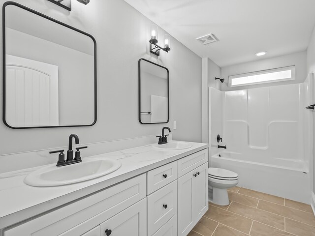 full bathroom featuring tile patterned flooring, vanity, bathing tub / shower combination, and toilet