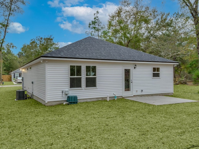 back of property featuring central AC unit, a patio area, and a lawn