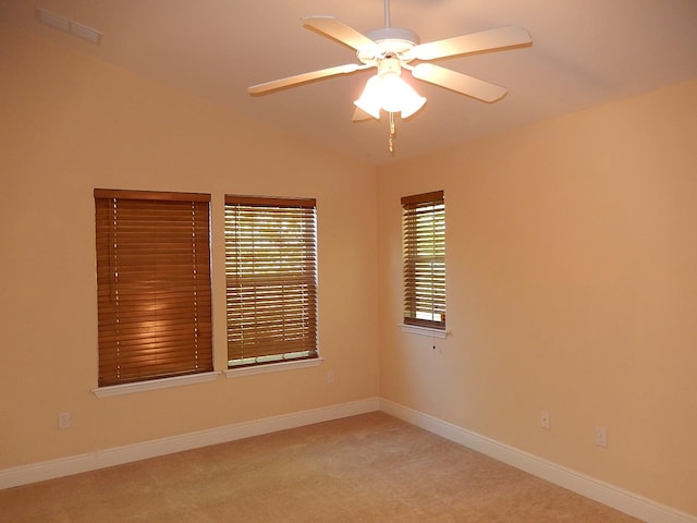 unfurnished room with ceiling fan, light carpet, and vaulted ceiling