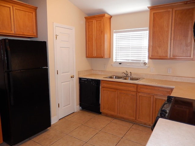 kitchen with light tile patterned floors, sink, vaulted ceiling, and black appliances