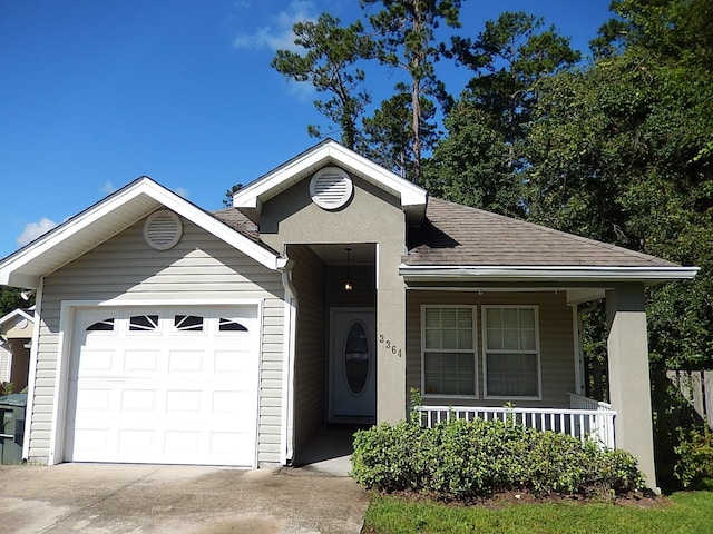 view of front of property with a porch and a garage