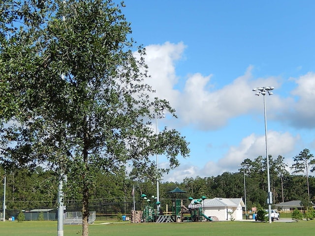 surrounding community featuring a playground and a yard