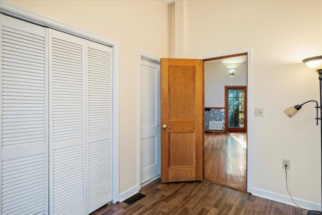 interior space featuring dark wood finished floors and baseboards