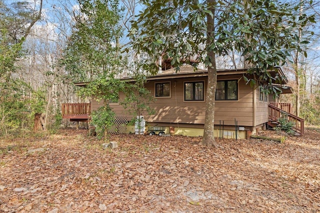 rear view of property featuring a deck