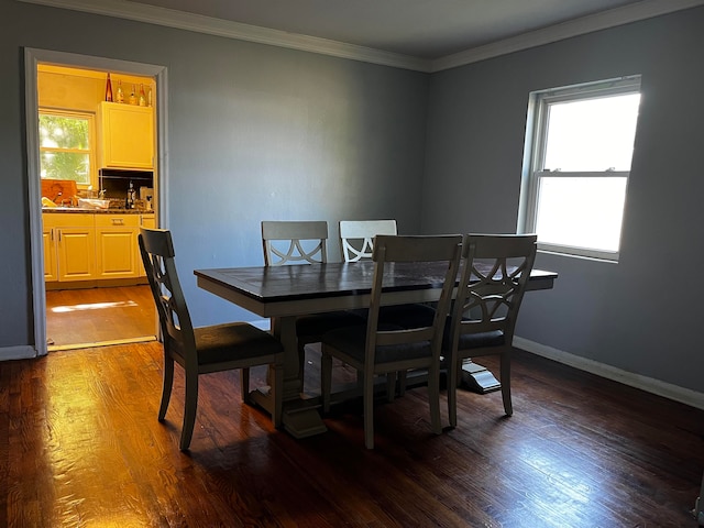 dining area with crown molding and dark hardwood / wood-style flooring