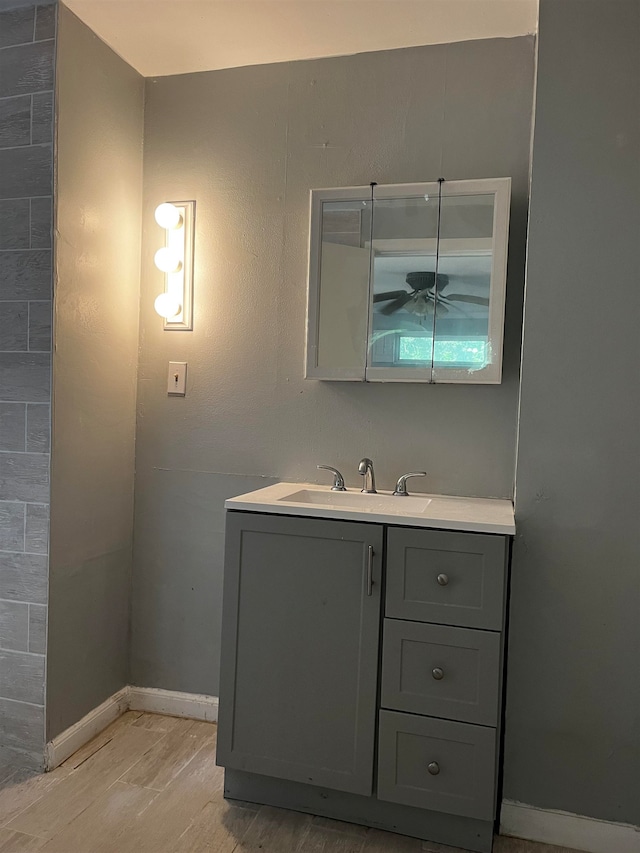 bathroom with ceiling fan, hardwood / wood-style floors, and vanity