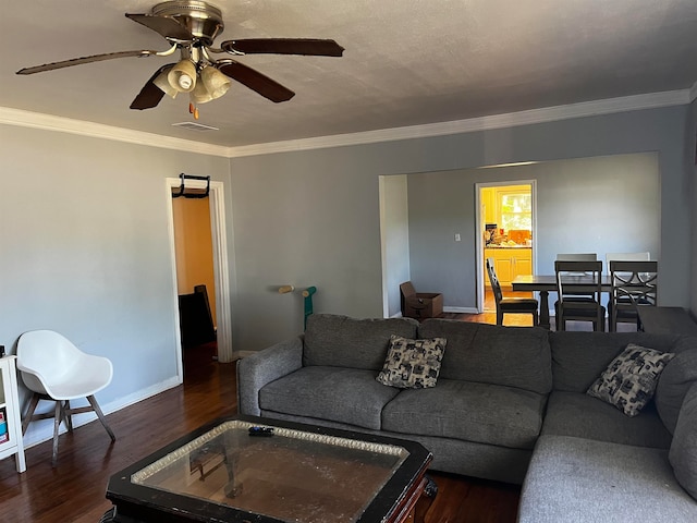 living room featuring ceiling fan, dark hardwood / wood-style flooring, and ornamental molding