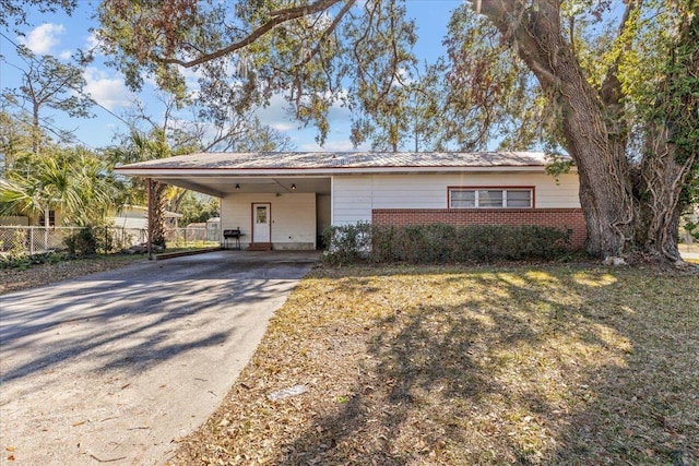 ranch-style house featuring a carport