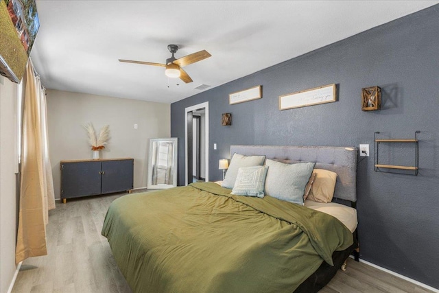 bedroom with ceiling fan and hardwood / wood-style floors