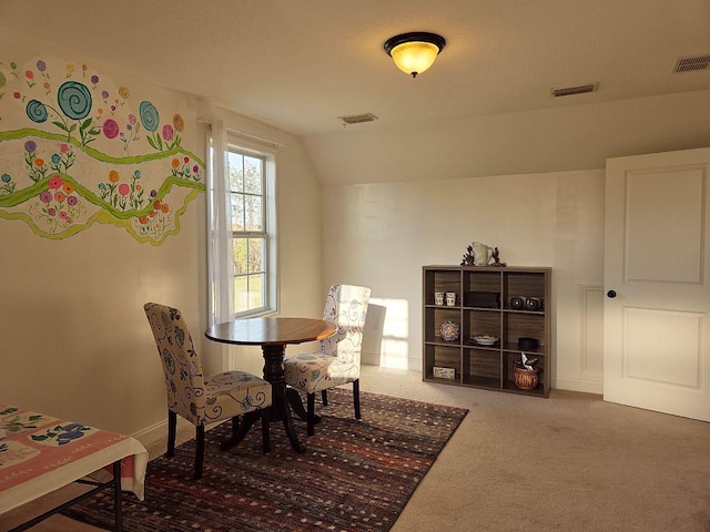 dining area featuring lofted ceiling, carpet flooring, and visible vents