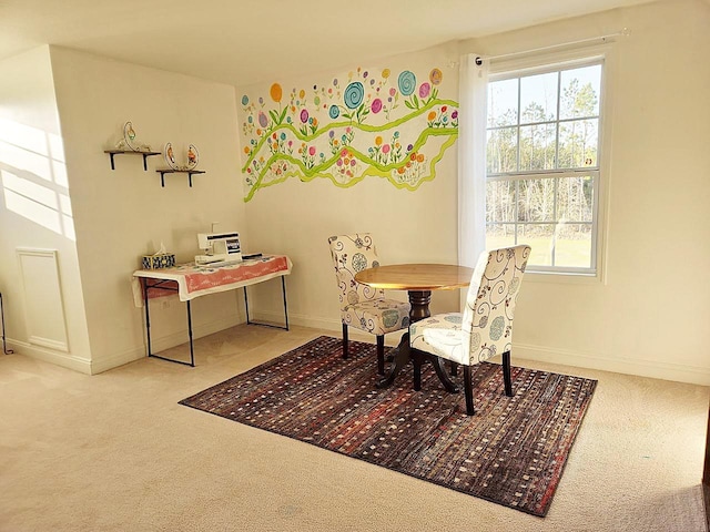 carpeted dining space with plenty of natural light and baseboards