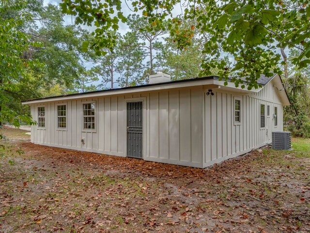 view of side of home with central air condition unit