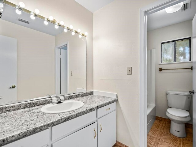 bathroom with toilet and vanity