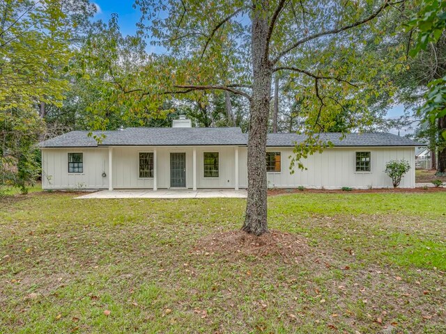 back of property featuring a yard and a patio area