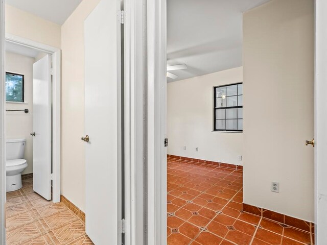 hall with tile patterned flooring