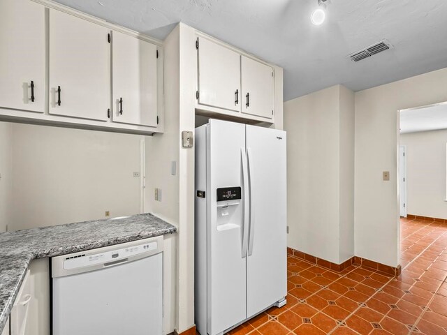 kitchen featuring white cabinetry and white appliances