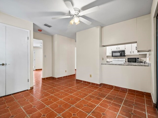 unfurnished living room with ceiling fan