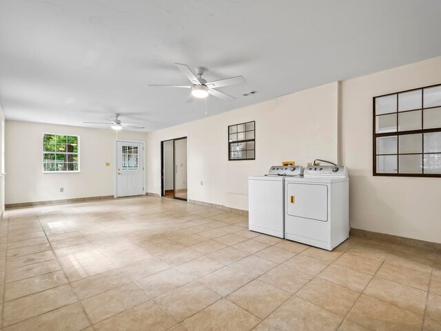 laundry room with ceiling fan, independent washer and dryer, and light tile patterned floors