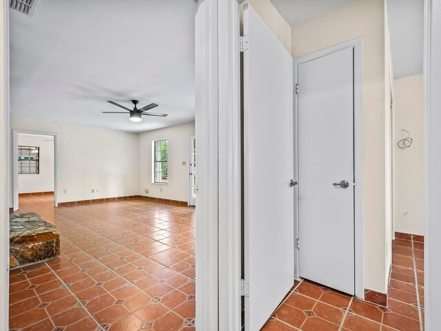 hallway with tile patterned flooring