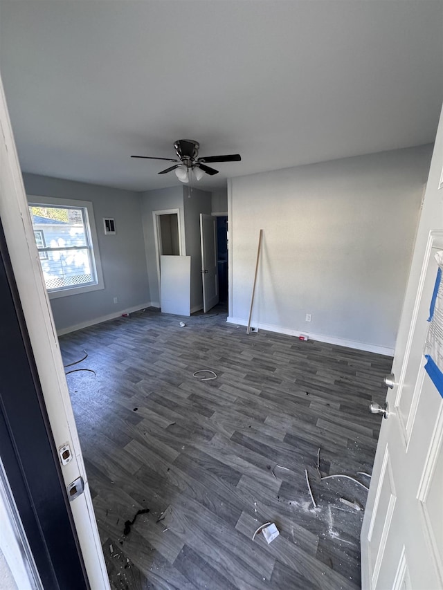 interior space featuring ceiling fan and dark hardwood / wood-style floors